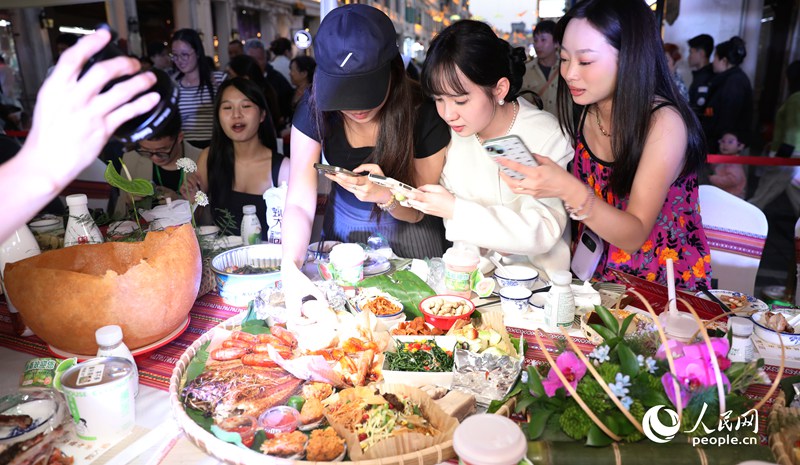 游客拍照打卡體驗長桌宴。人民網(wǎng)記者 符武平攝